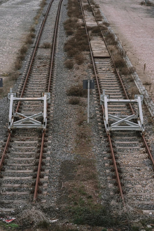 an old railroad crossing has two rails missing