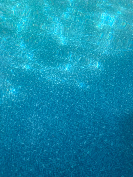 the surface of a swimming pool that looks like they are made from pebbles