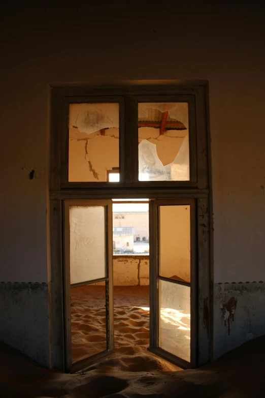 an open window inside an old rundown house