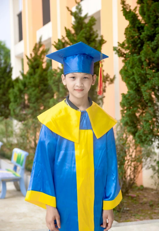 a little boy in a graduation cap and gown