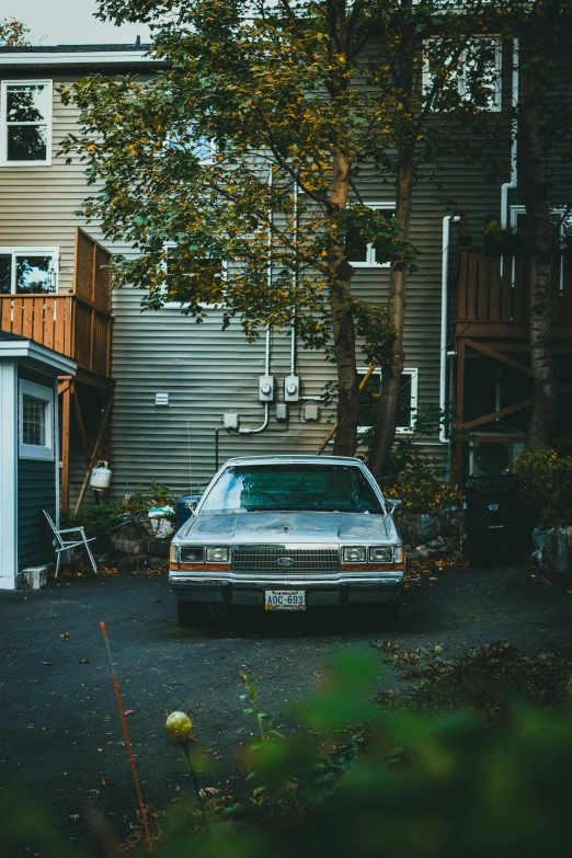 a white car is parked next to a building