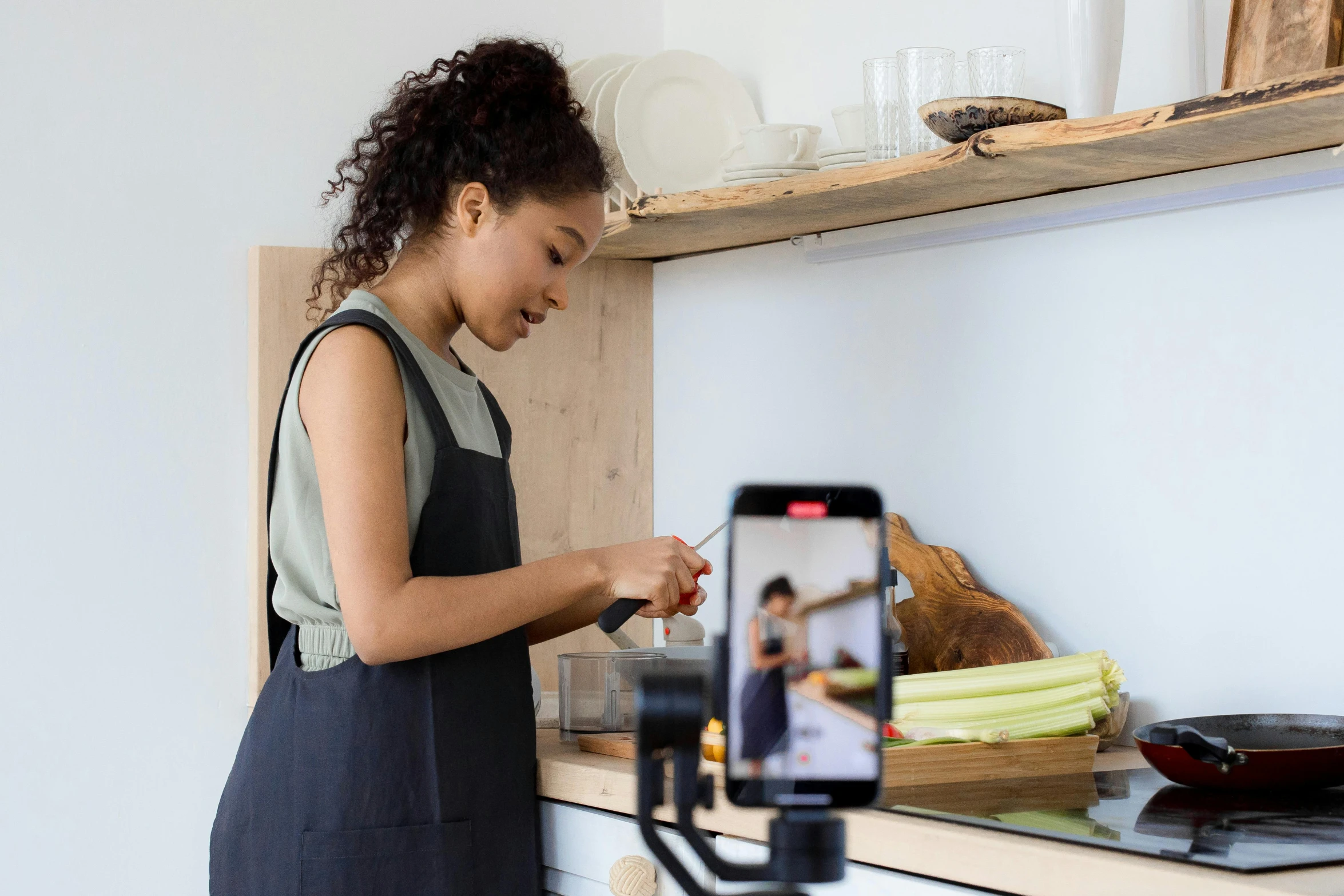 a woman takes a picture of food with a phone