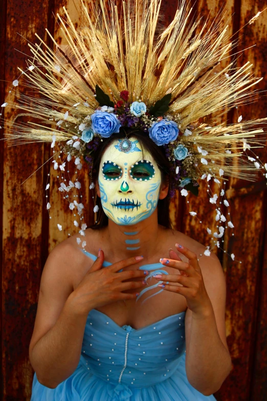 a woman wearing a skull make up in blue is pographed