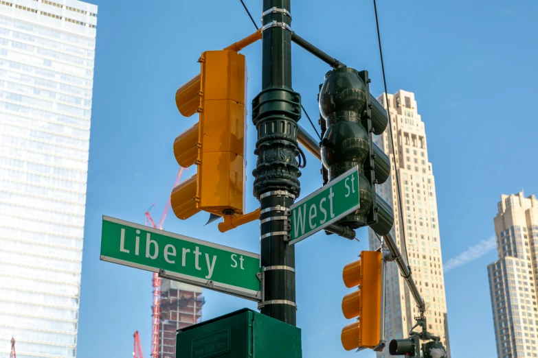 a traffic light next to a street sign on liberty street