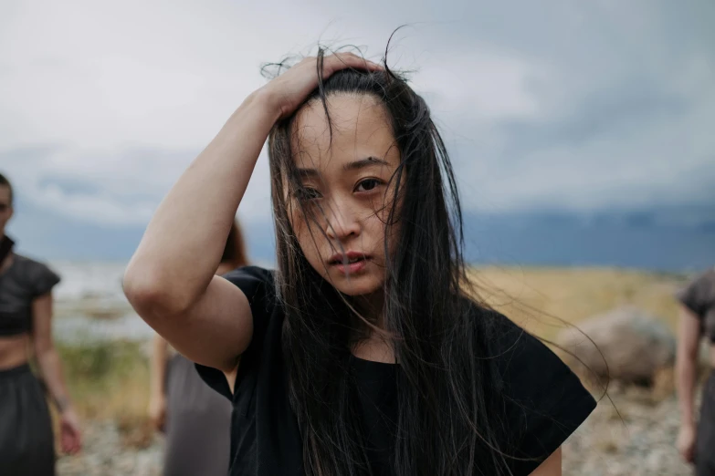 two girls standing next to each other in a barren area