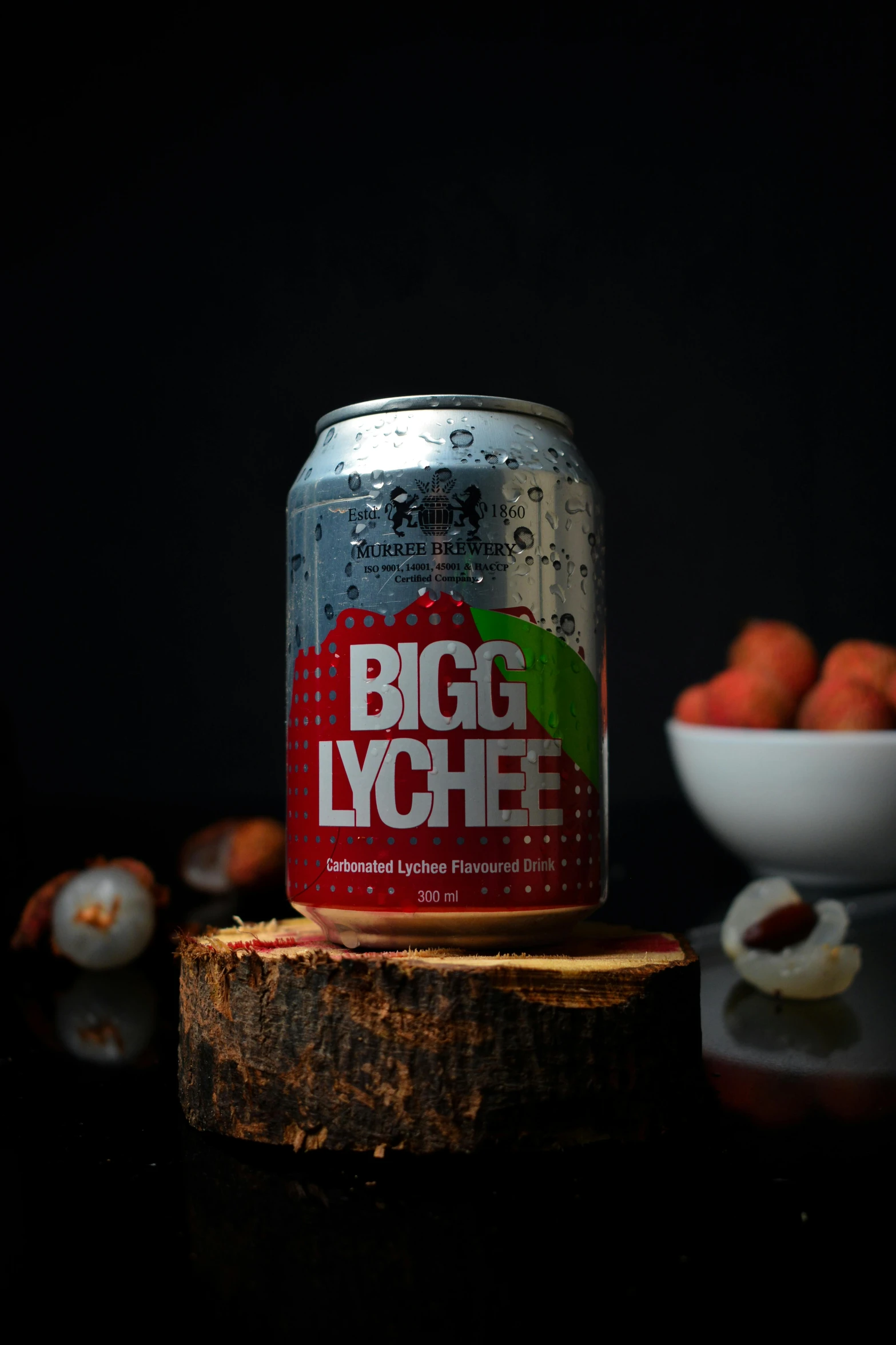 a big lygee canned can of beer on top of a wooden stump