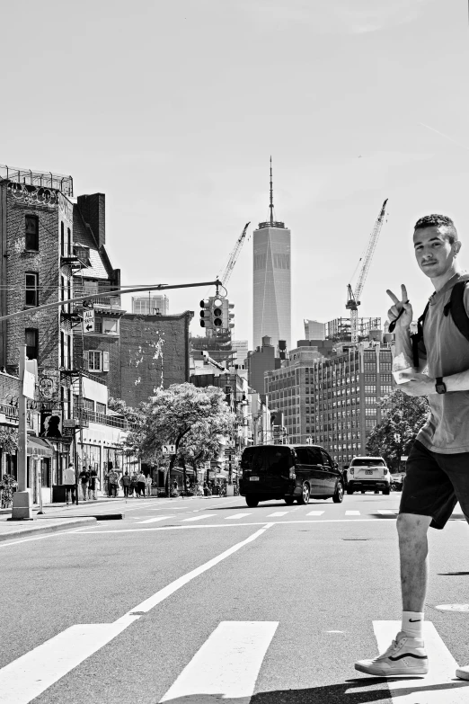 a man is running down the street with a lot of buildings