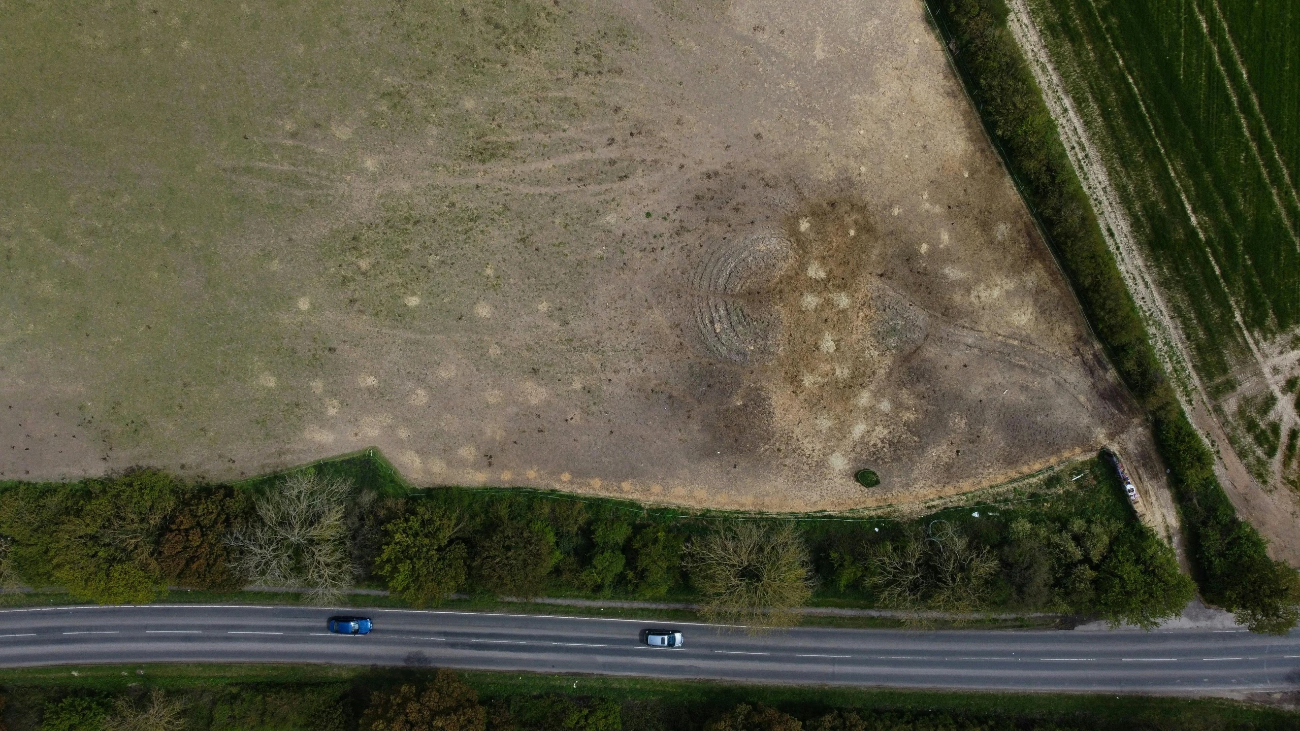 a field and road with trucks on it