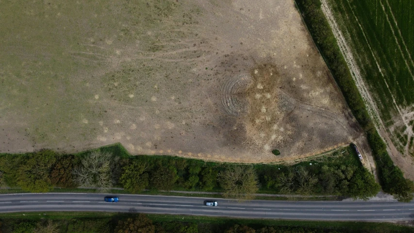 a field and road with trucks on it