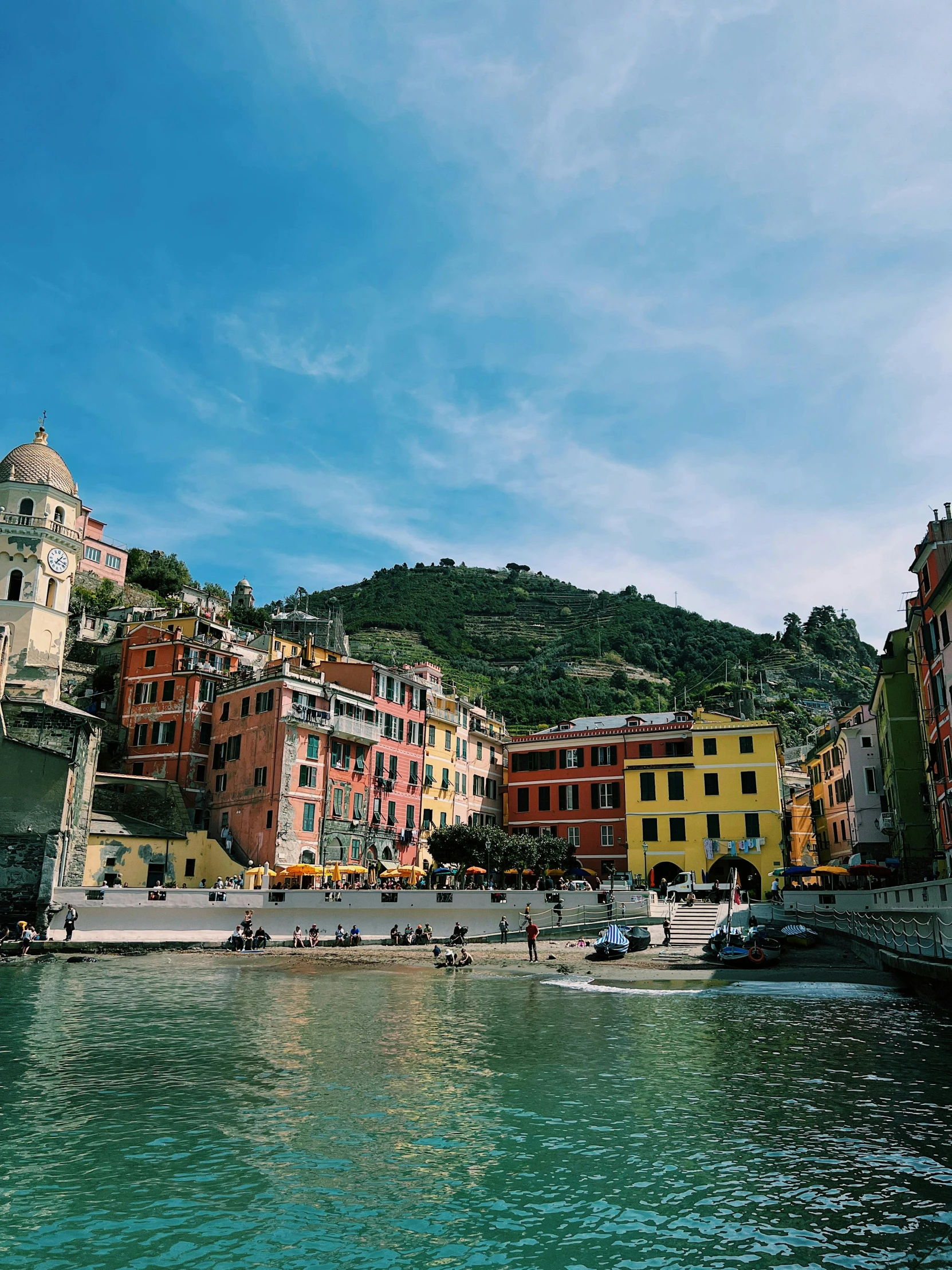 a number of people walking around a city on the water