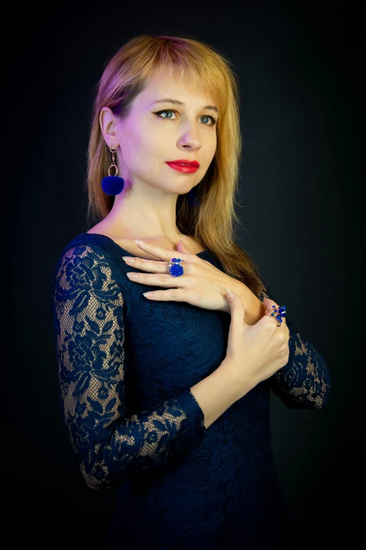 a woman posing for a picture with her hands on her chest