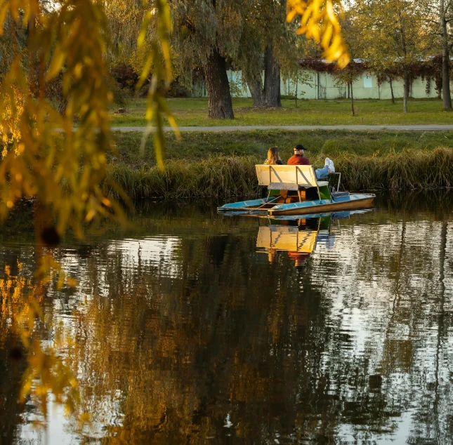 people on a blue pontoon boat at sunset