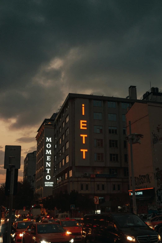 street full of traffic under an ominous dark sky