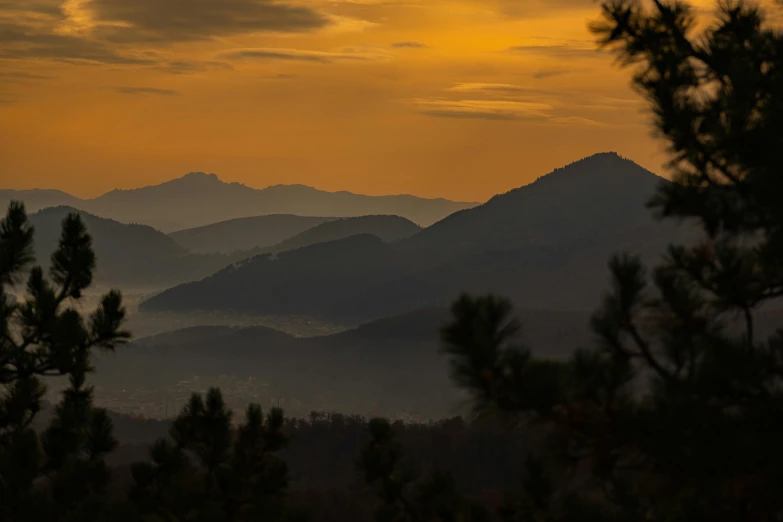 a po taken looking out over a landscape with trees and mountains in the distance