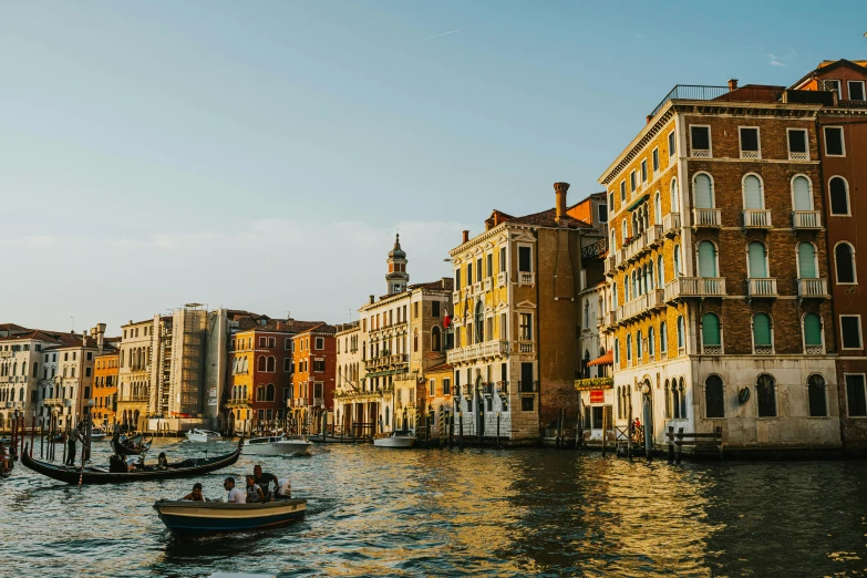 a bunch of buildings on a canal with people