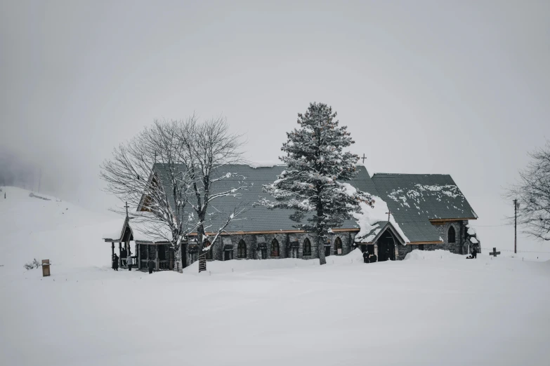 a large home sitting in a snow covered mountain