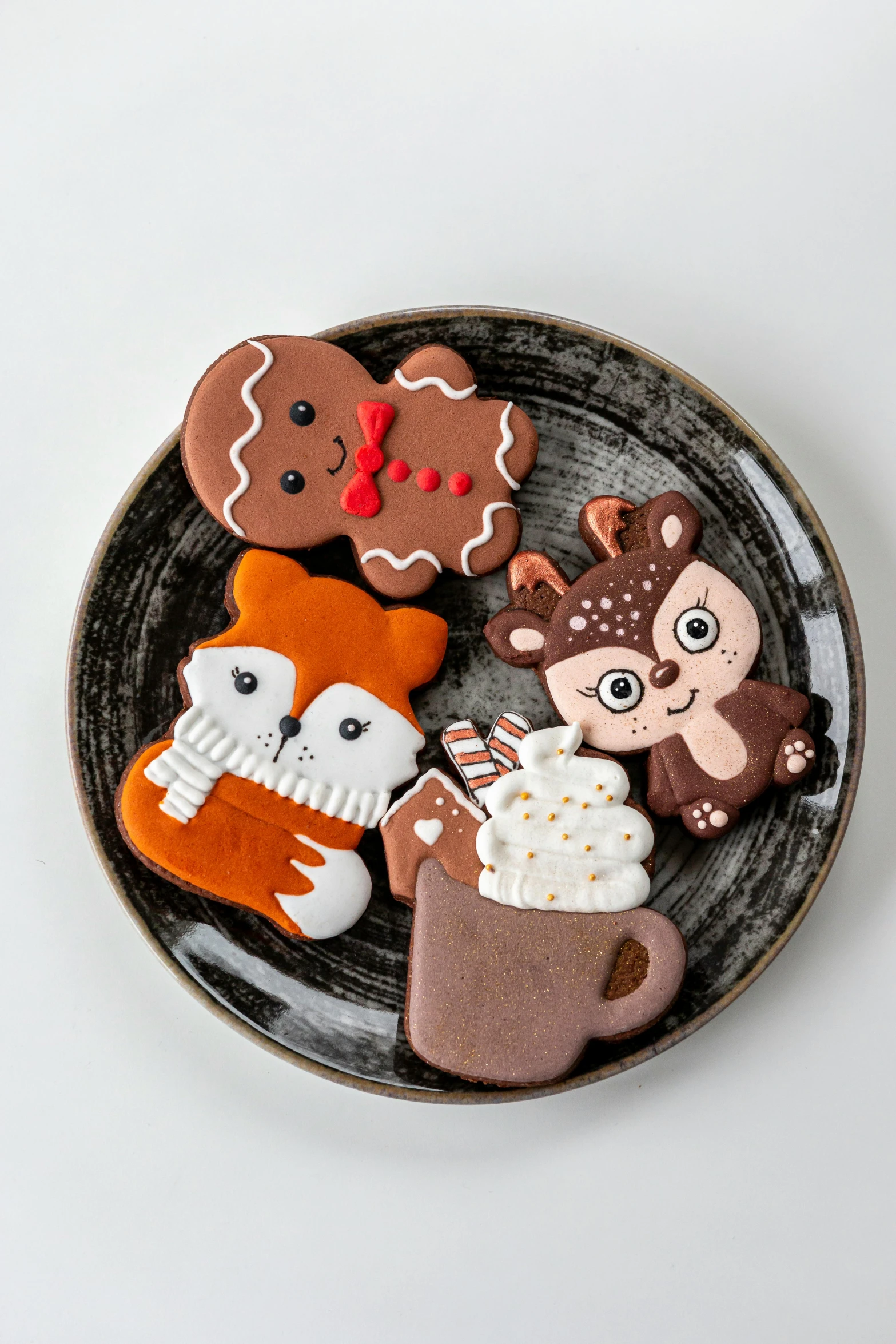 a plate with cookies and other cookie decorations