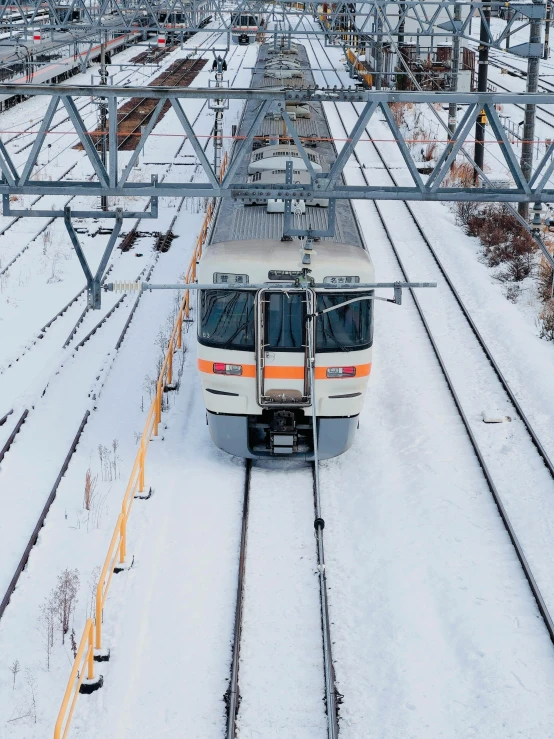 a train moving on tracks in the snow