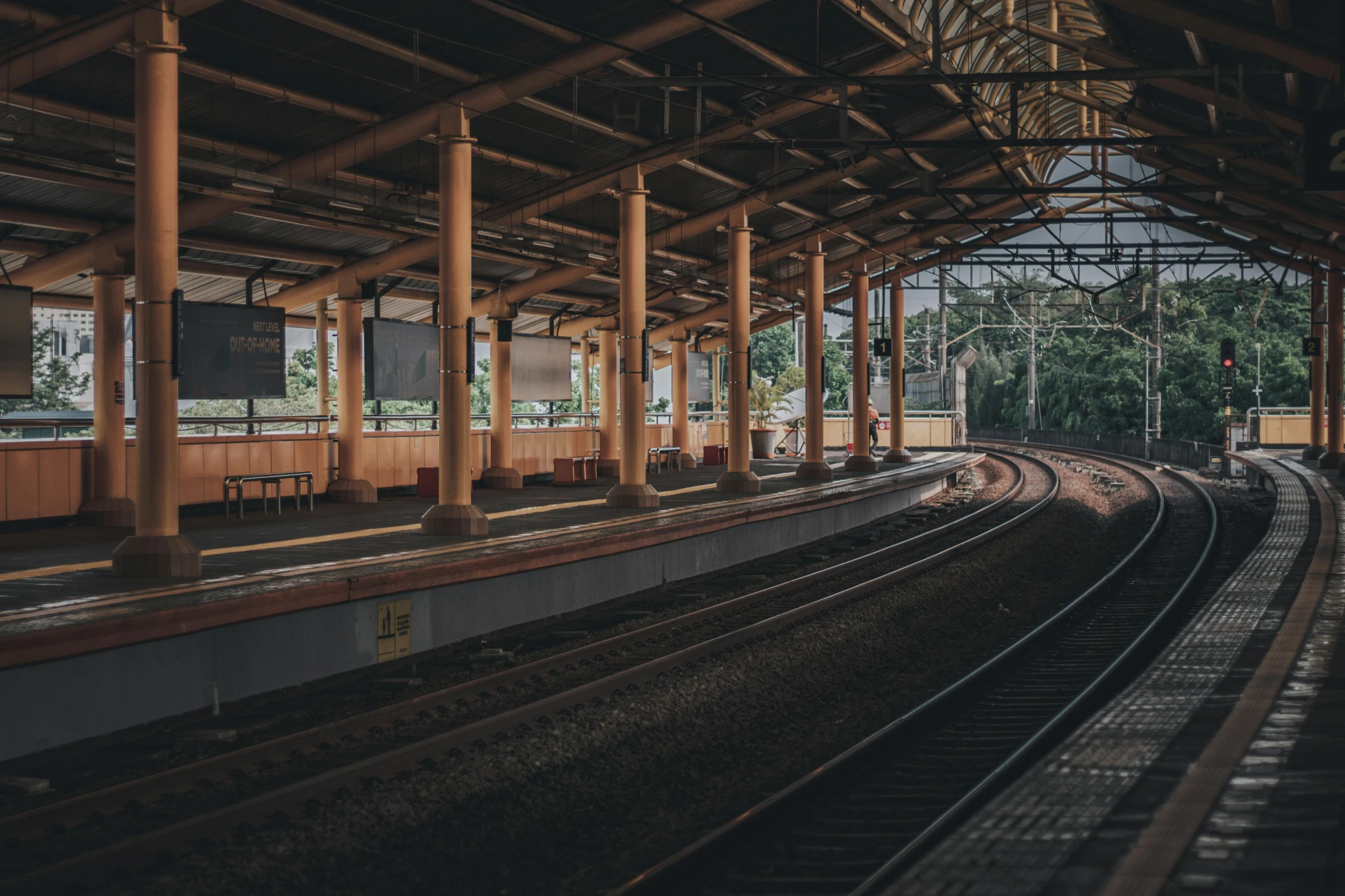 the train is pulling into the platform where several people are waiting