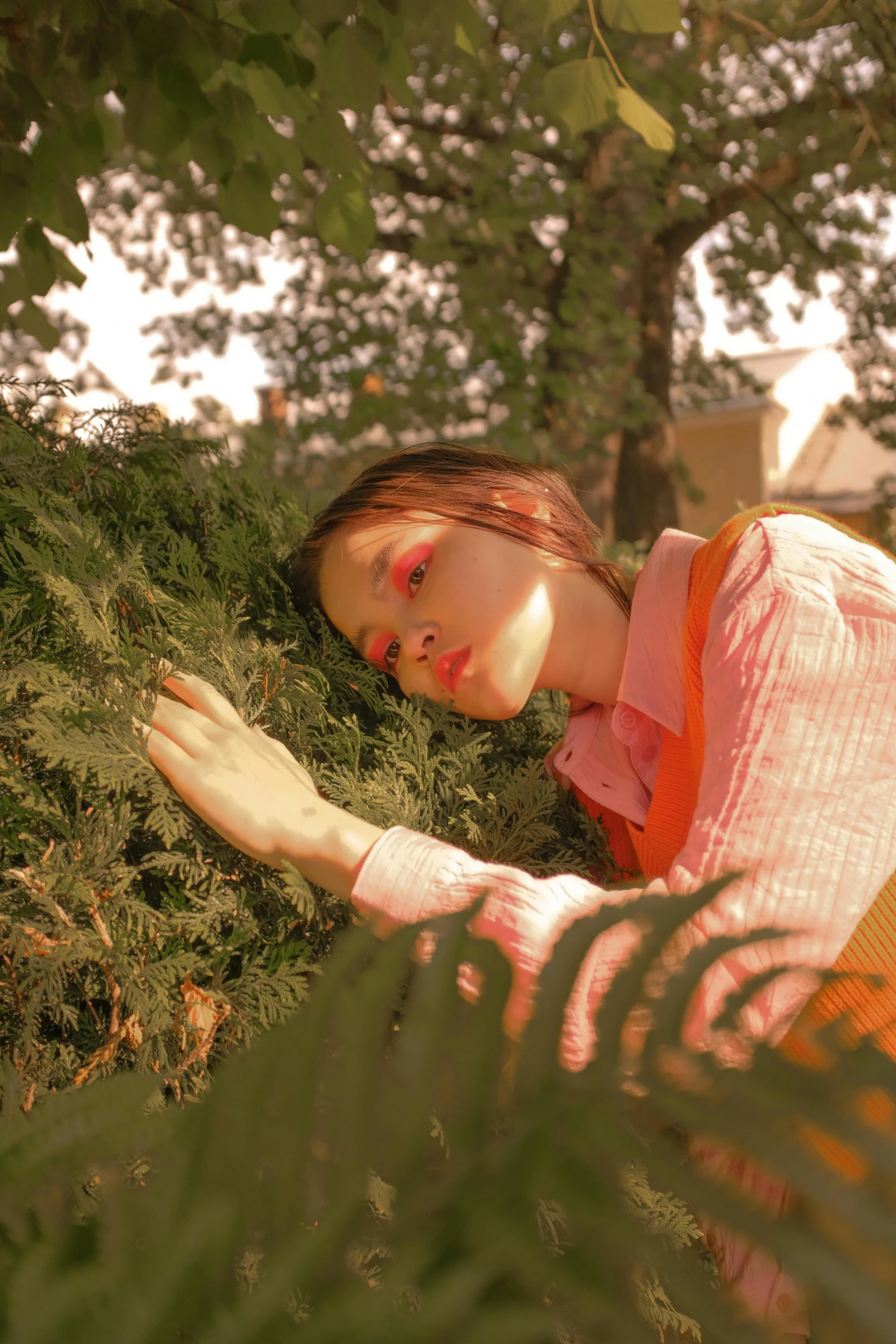 woman is lying down in a grass field