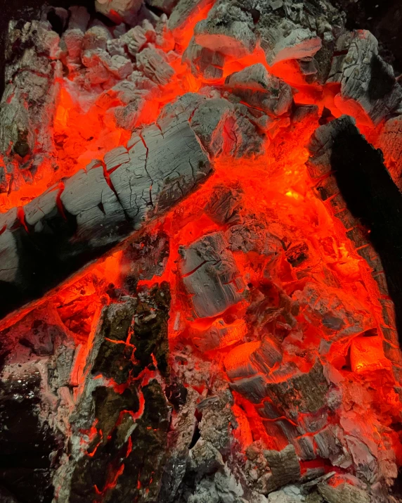  coal and lava from a volcano with glowing red flames