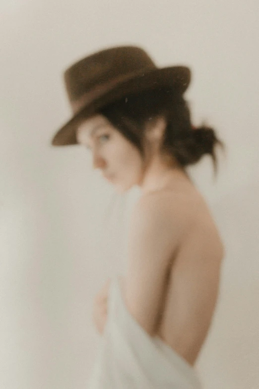 a blurry po of a woman in a hat