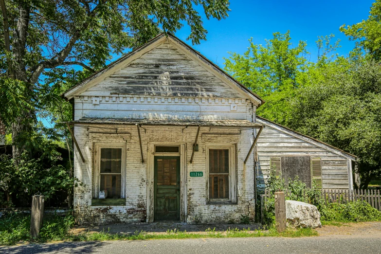 an old run down wooden house with broken doors