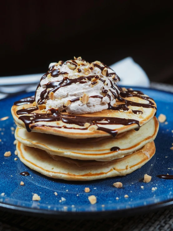 chocolate covered dessert with sprinkles atop pancakes