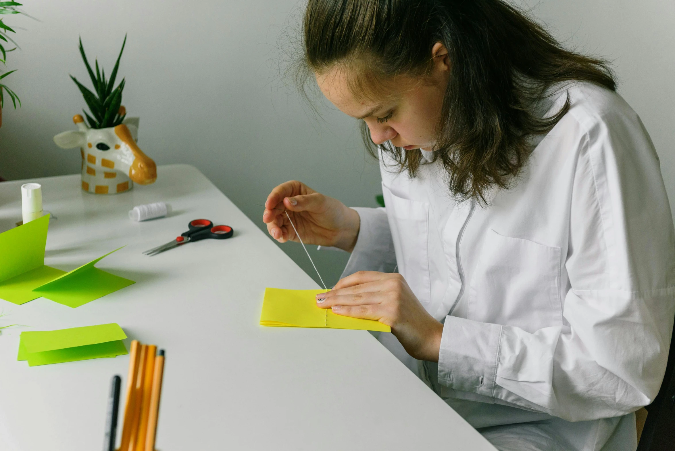 a woman working on crafting pieces of paper