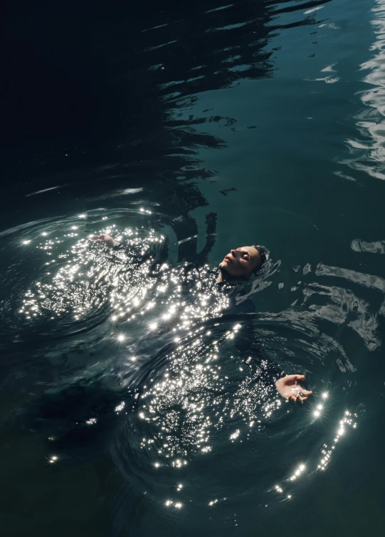 a body of water with two people swimming