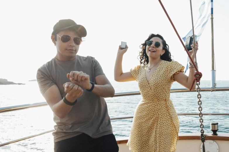 a woman and a man on a boat by a chain