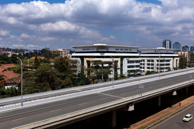 a highway with cars on the side of it and a building in the background