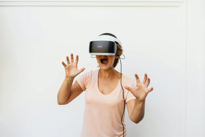 a woman wearing a headset has her hands raised to hear soing