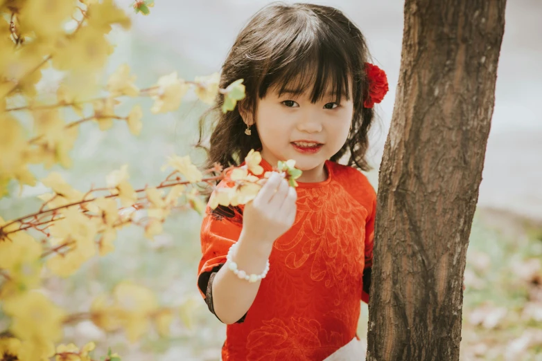 a little girl that is standing near some trees