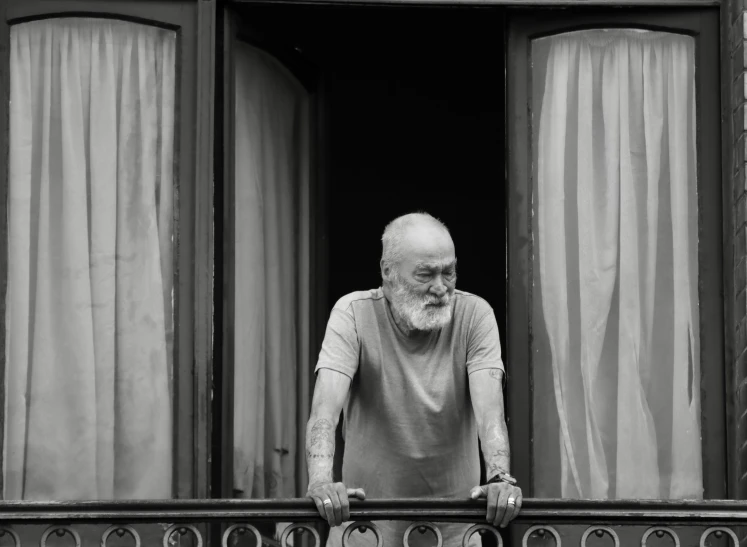 a man looking out of a window that is closed