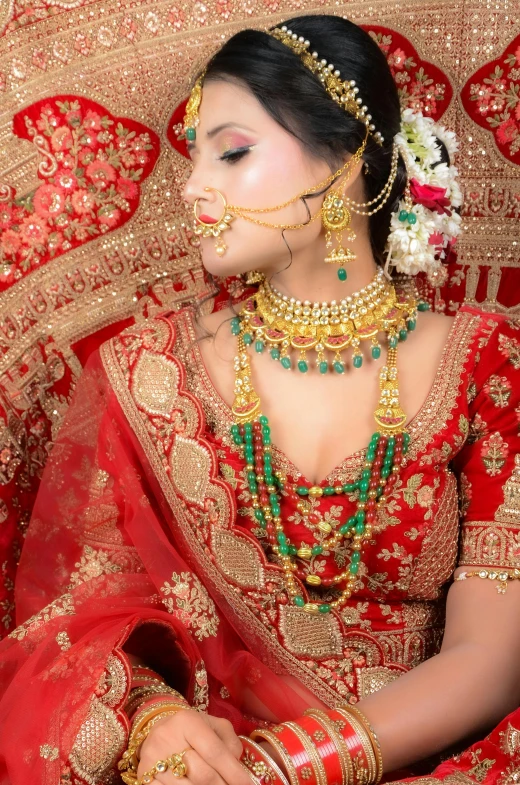 a woman with her hands on her knees while wearing jewellery