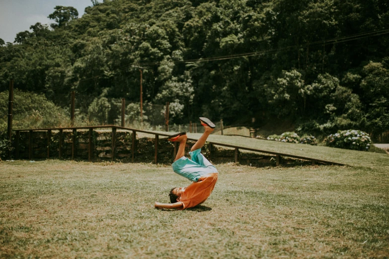 a man is playing frisbee in the grass