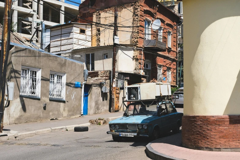 a small truck is parked next to some buildings