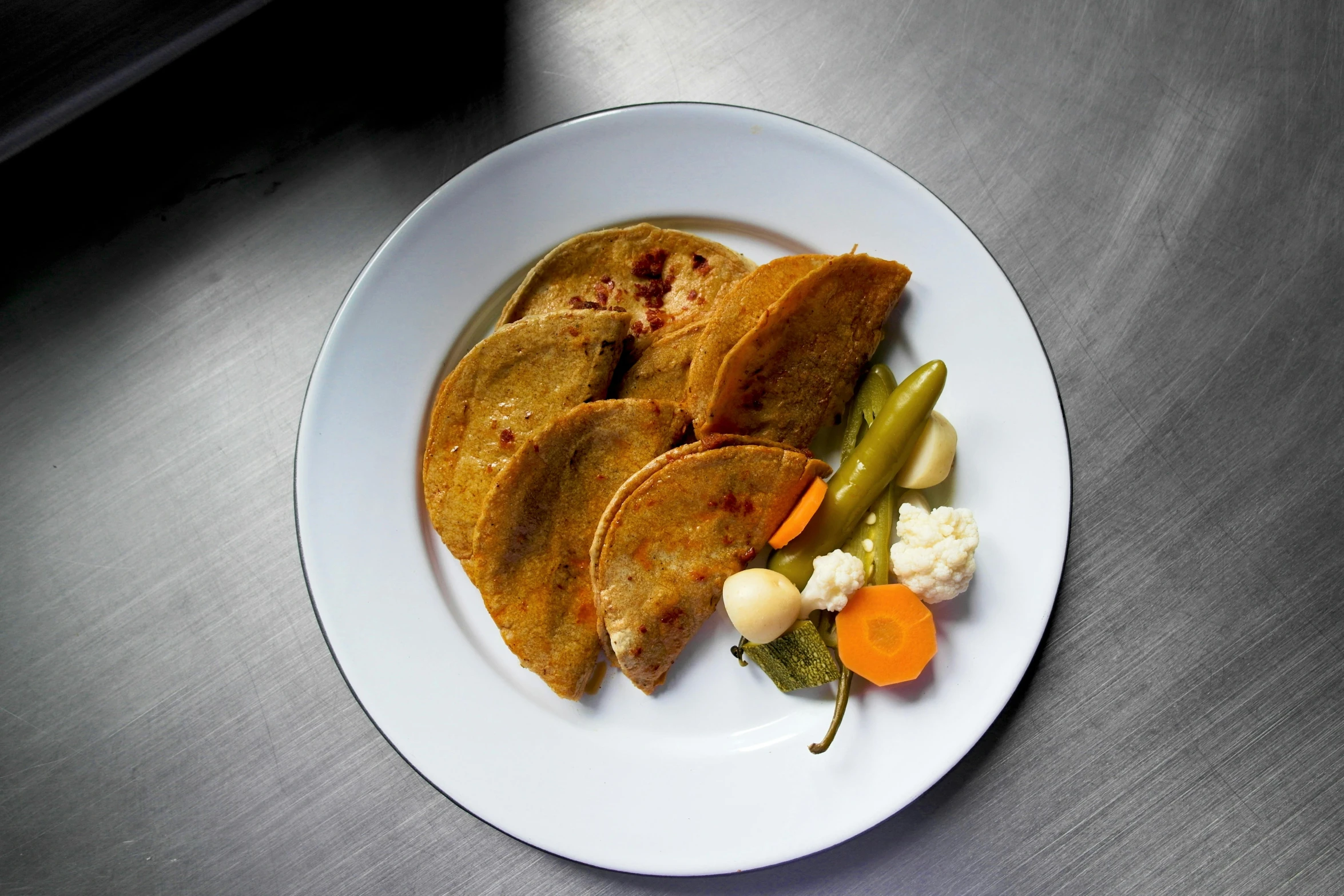 some veggies and bread on a white plate