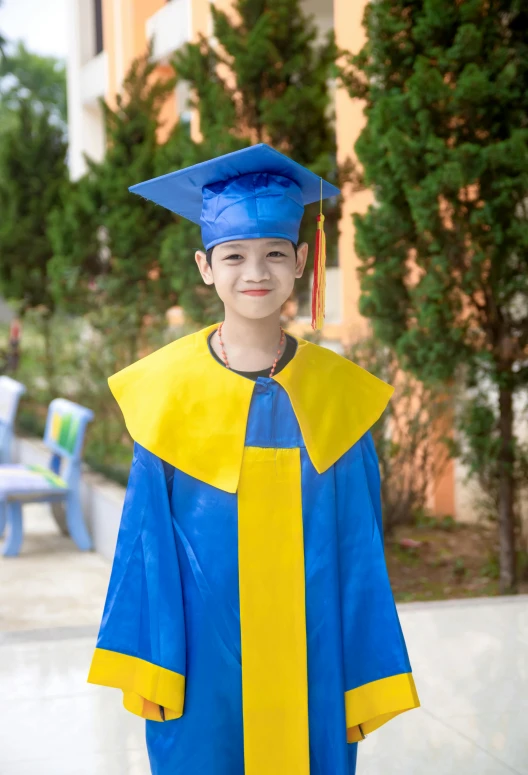 a child in graduation gown and cap