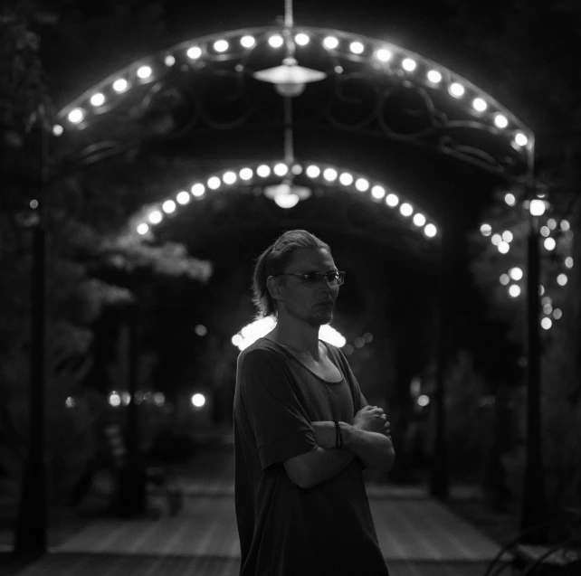 a woman standing under a light covered street