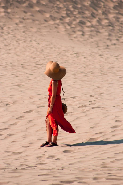 there is a person in the sand and hat