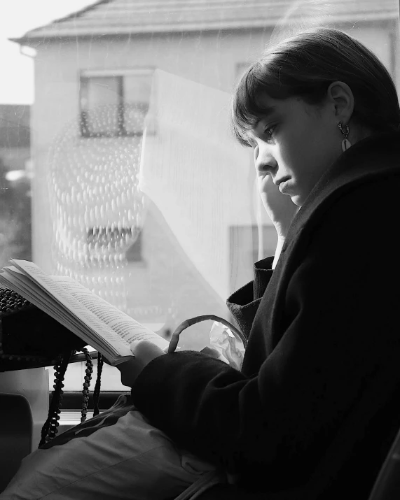 woman reading a book on a screened balcony