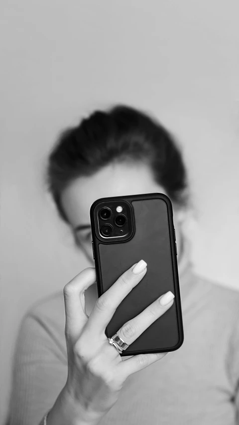 black and white pograph of a woman holding her phone