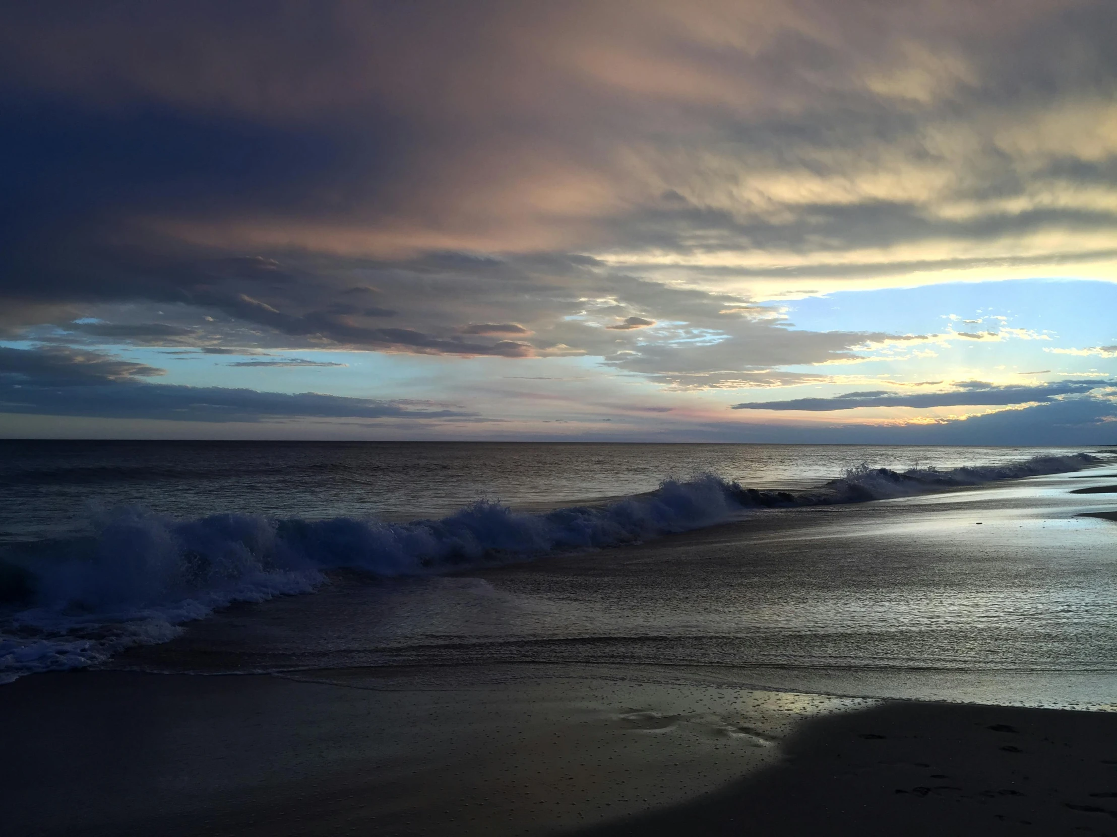 a picture of the ocean and a sunset at beach