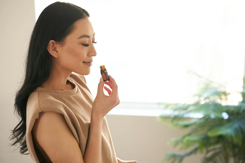 a woman looks through a bottle of lip polish