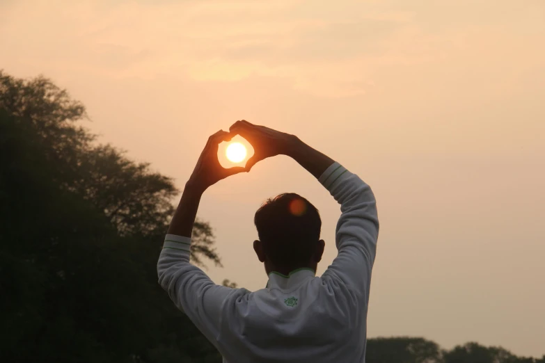 a man is holding a lit item up in the air