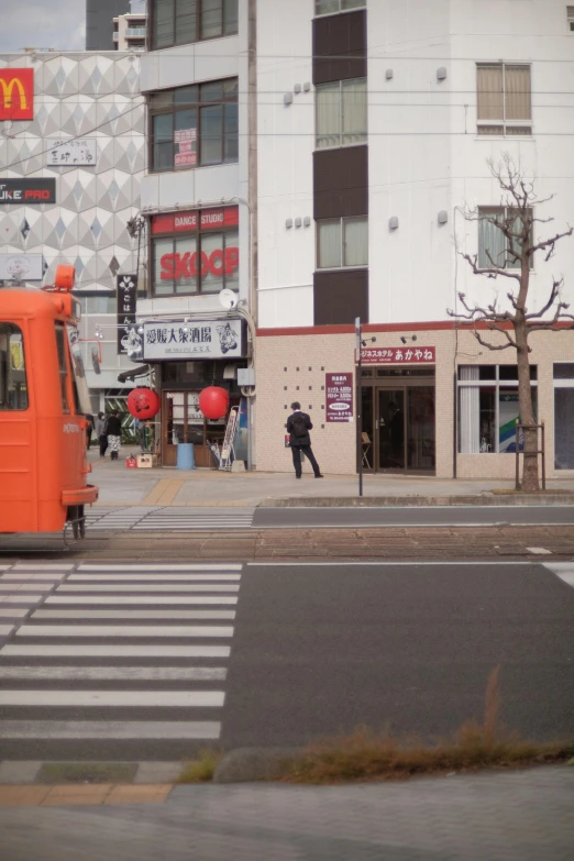 an orange traffic light sitting in front of a building