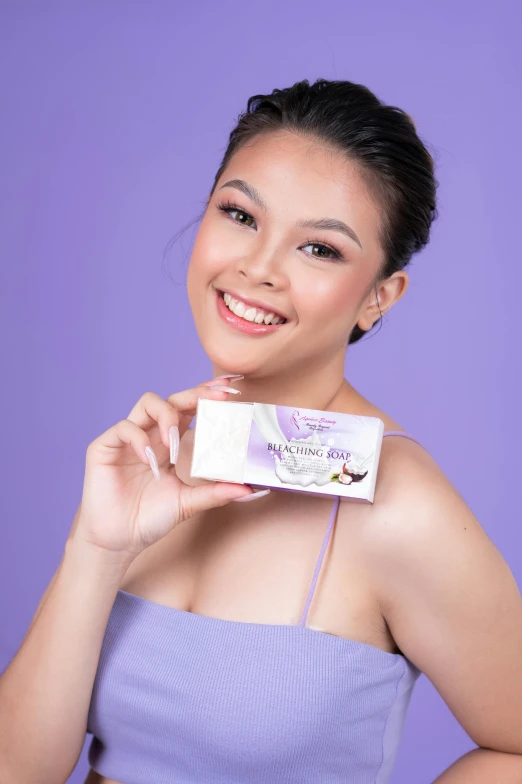 a woman holding a box of baby powder