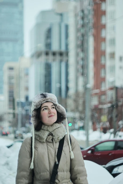 there is a woman walking down a snow covered street